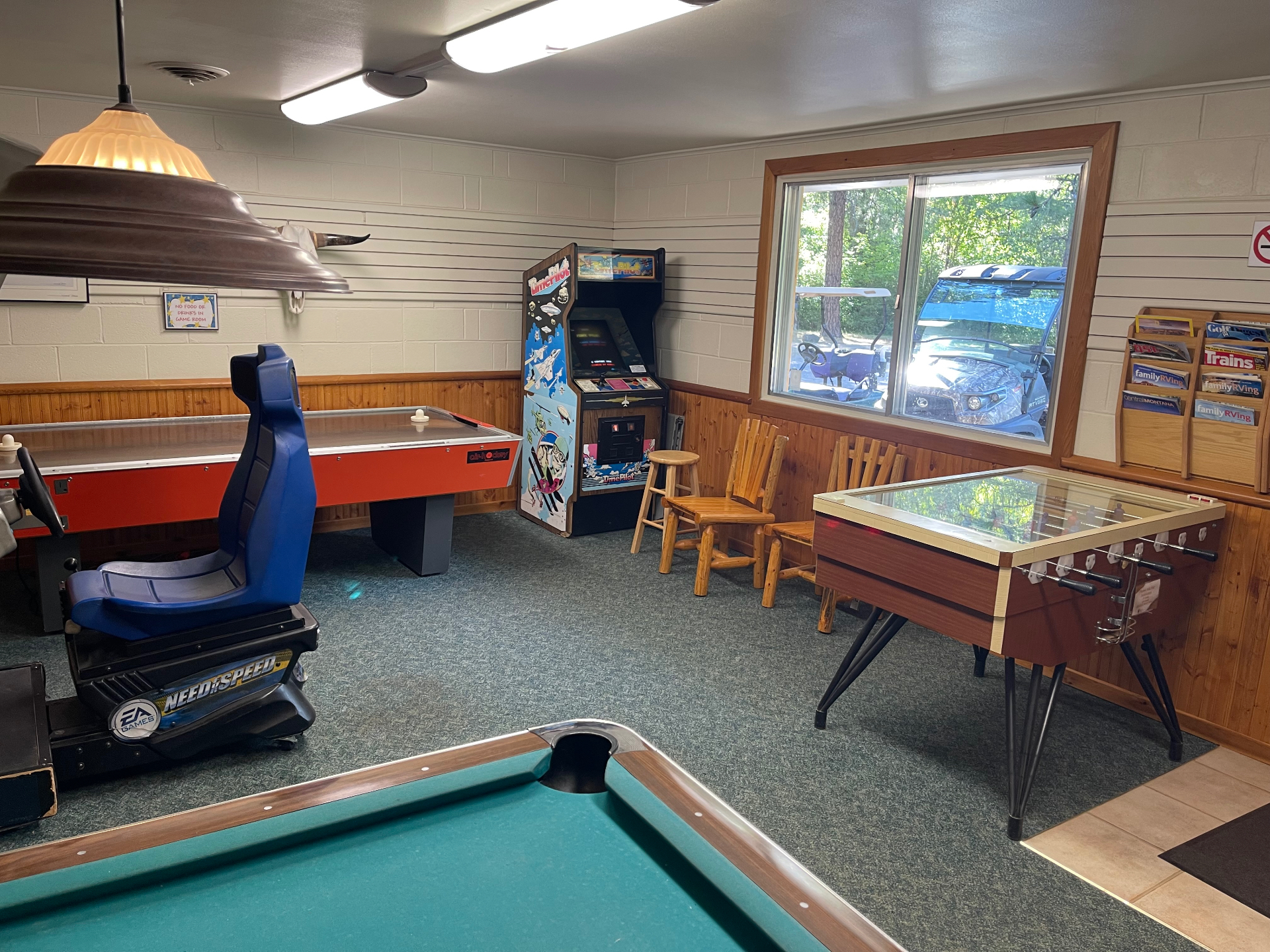 Game room with air hockey table, Time Pilot arcade cabinet, foosball table and log chairs