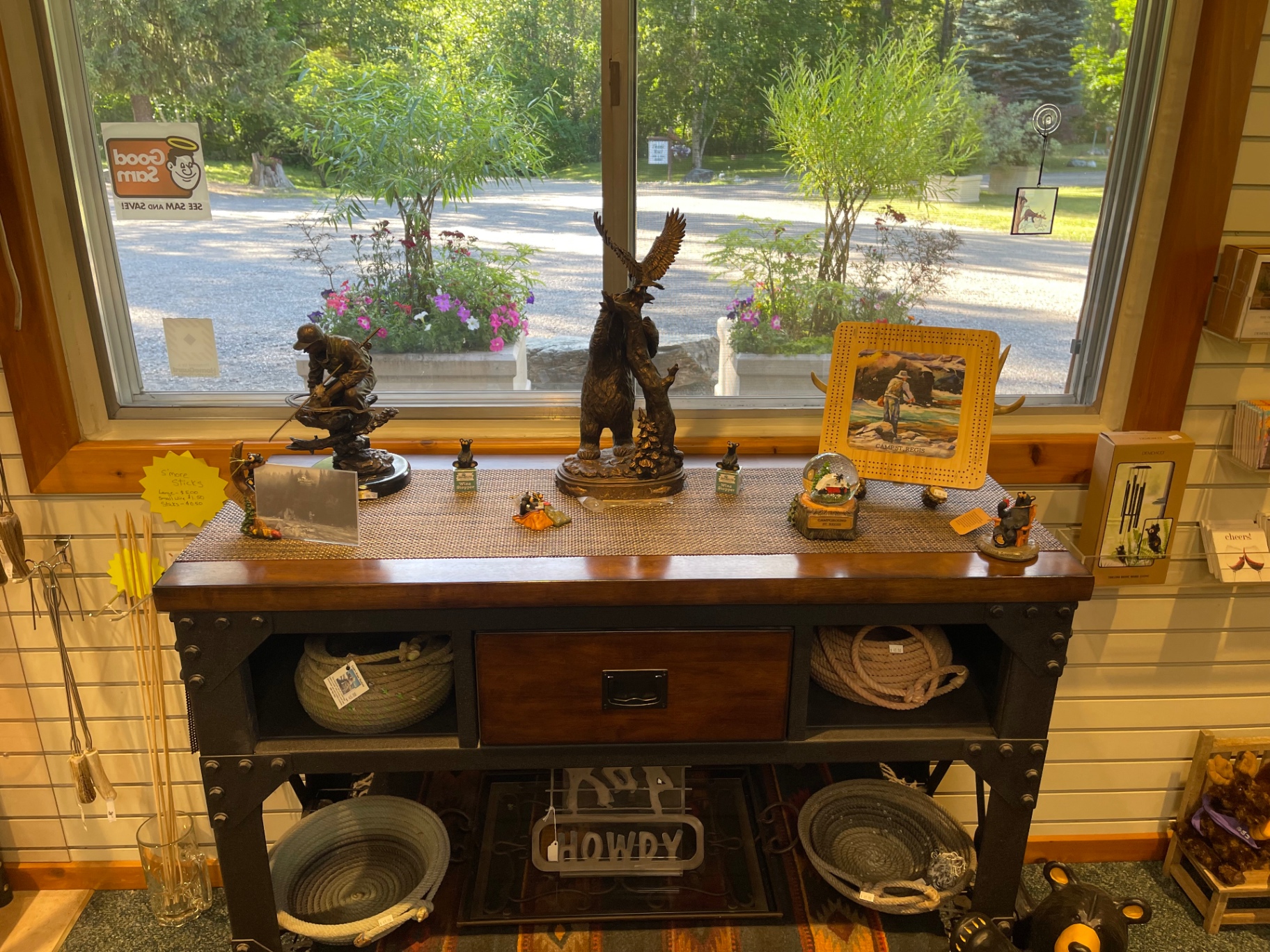 Bronze wildlife sculptures, St. Regis cribbage boards and snow globes on a display table