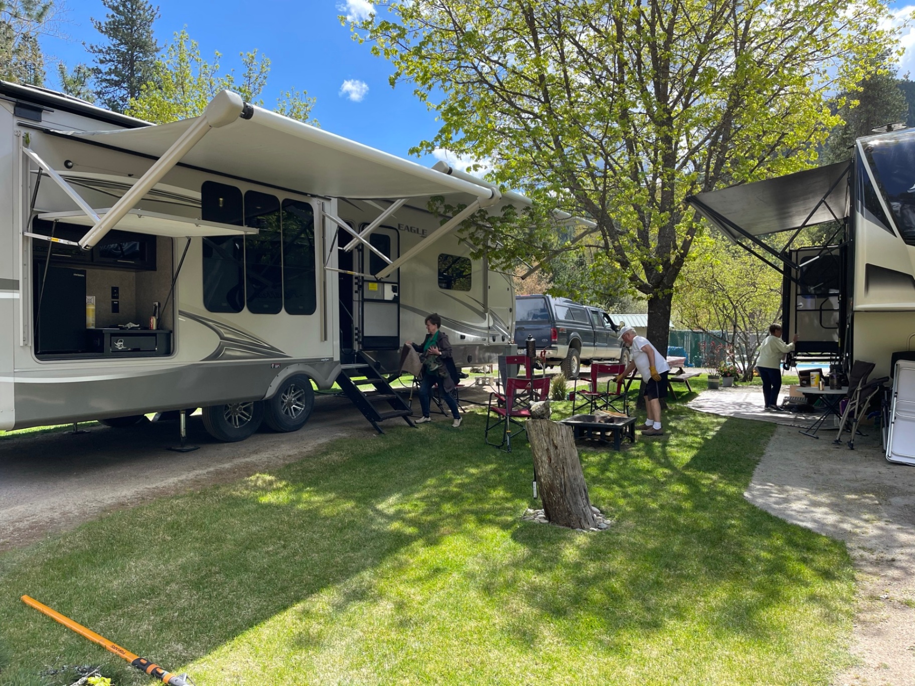 RVs with awnings out on a sunny spring day with guests settling in